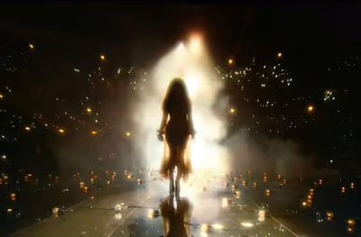 Performers silhouetted in stage smoke and haze